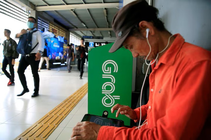 Grab, GoTo hạ chiết khấu từ 20% xuống 8% tại Indonesia (Ảnh: Reuters)