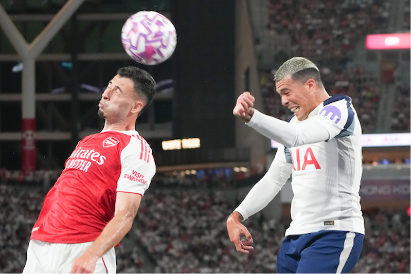 Gabriel Martinelli (trái) của Arsenal và Pedro Porro của Tottenham trong trận đấu tại sân vận động Kai Tak năm ngoái. Kraken, một nền tảng giao dịch tài sản ảo, là nhà tài trợ tay áo (logo màu tím) của Spurs. (Ảnh: SMPC)